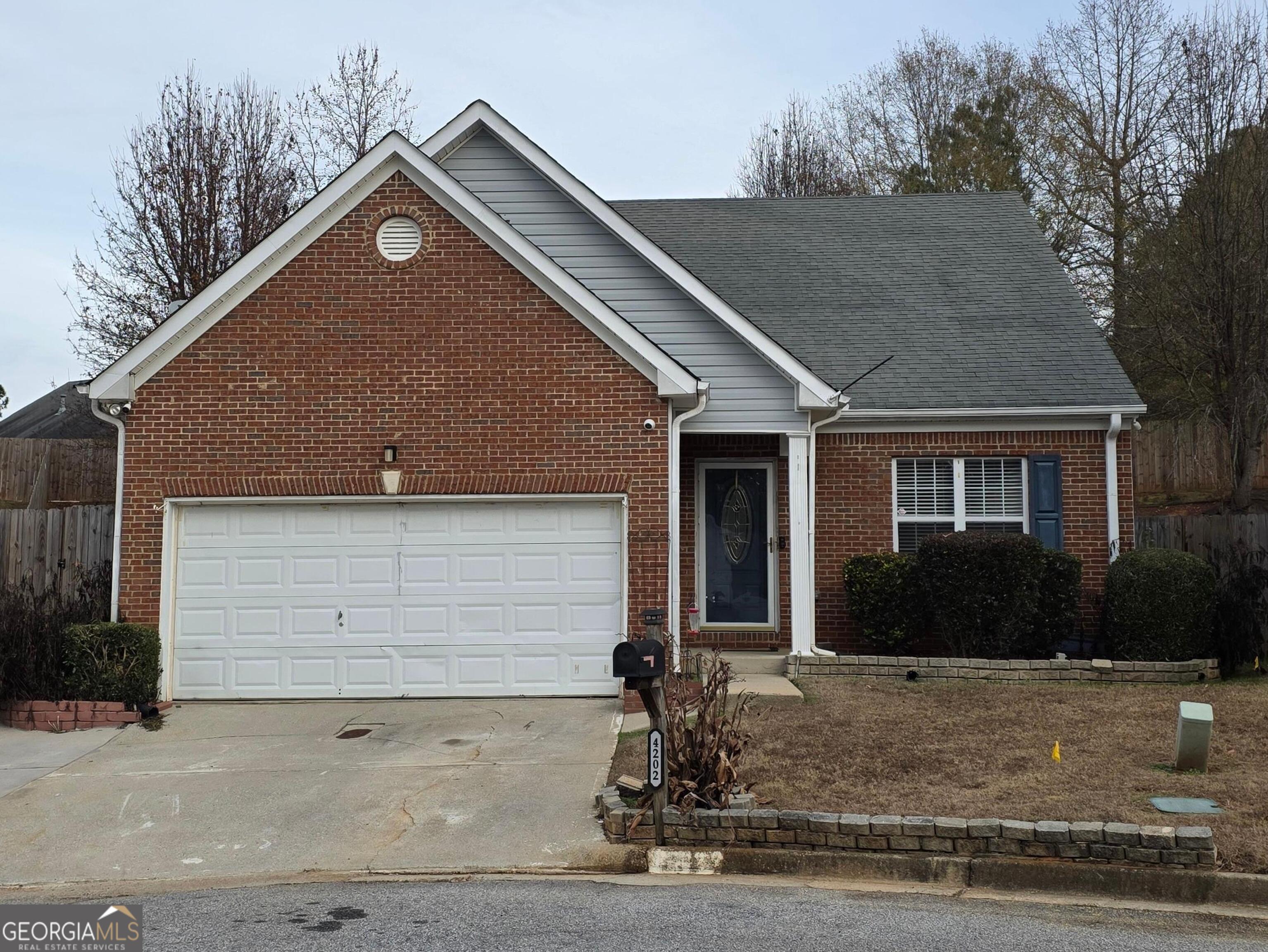 4202 Wesley Hall Lane Decatur, GA 30035 - Photo 1 of 2 a front view of a house with garden