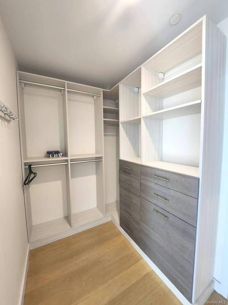 131-01 40 Road, Unit 19Z Queens, NY 11354 - Photo 4 of 9 a view of walk in closet with empty racks