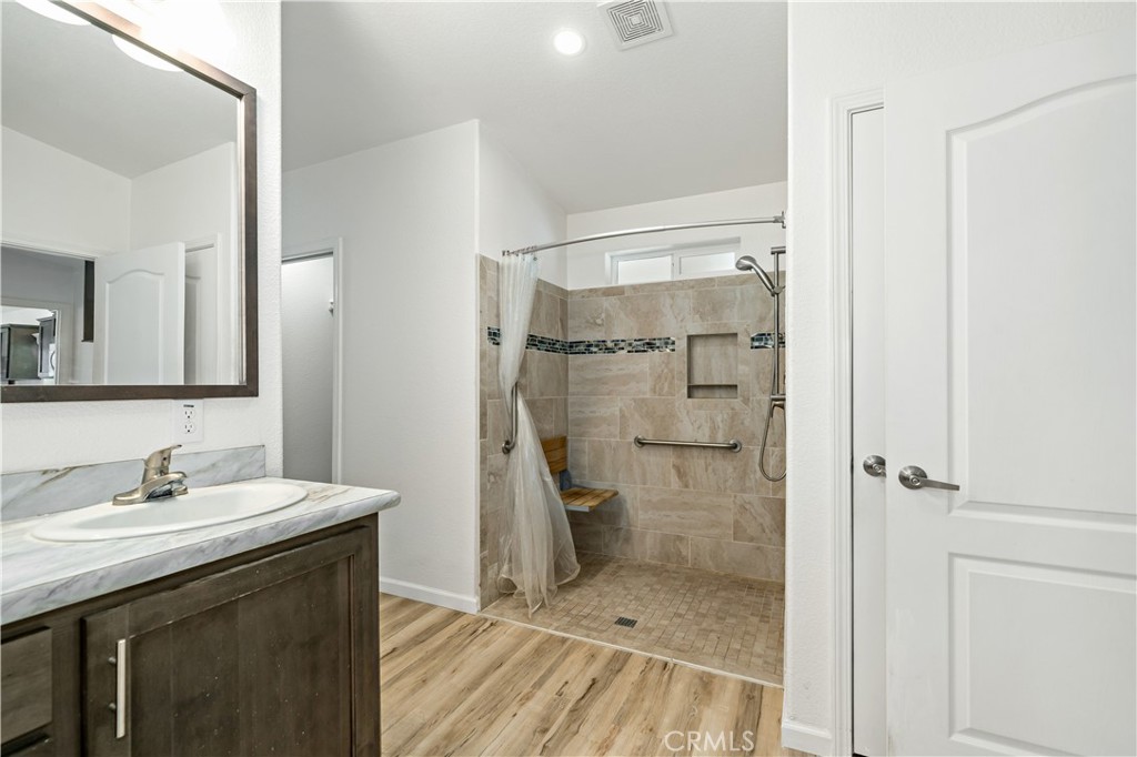 4650 Dulin Road, Unit 39 Fallbrook, CA 92003 - Photo 19 of 39 a bathroom with a shower sink and mirror