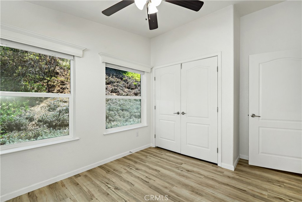4650 Dulin Road, Unit 39 Fallbrook, CA 92003 - Photo 21 of 39 a view of an empty room with wooden floor and a window