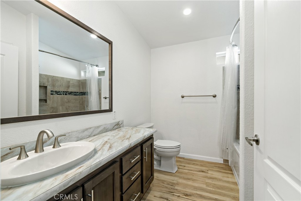 4650 Dulin Road, Unit 39 Fallbrook, CA 92003 - Photo 22 of 39 a bathroom with a granite countertop sink toilet and mirror