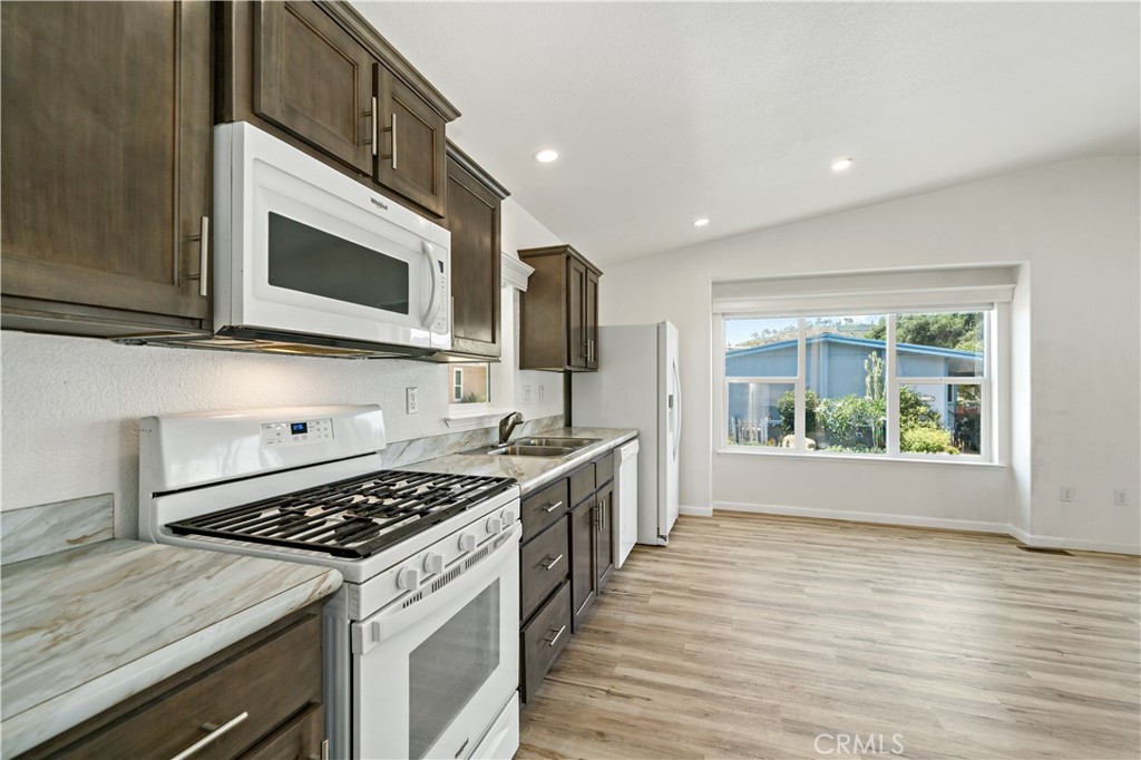 4650 Dulin Road, Unit 39 Fallbrook, CA 92003 - Photo 7 of 39 a kitchen with stainless steel appliances granite countertop a stove and a microwave
