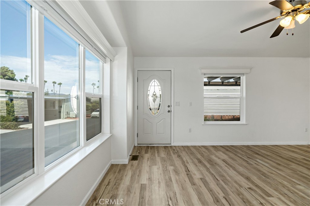 4650 Dulin Road, Unit 39 Fallbrook, CA 92003 - Photo 10 of 39 a view of a livingroom with wooden floor and a ceiling fan