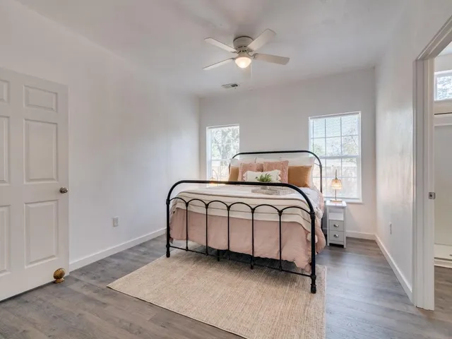 a bedroom with a bed a window and closet