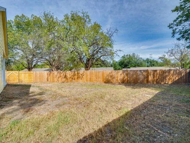a backyard of a house with a tree