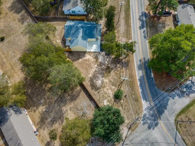 an aerial view of a house with a yard