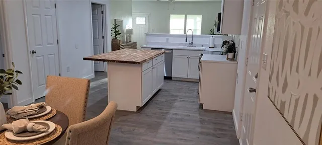 a bathroom with a granite countertop sink a toilet and a mirror