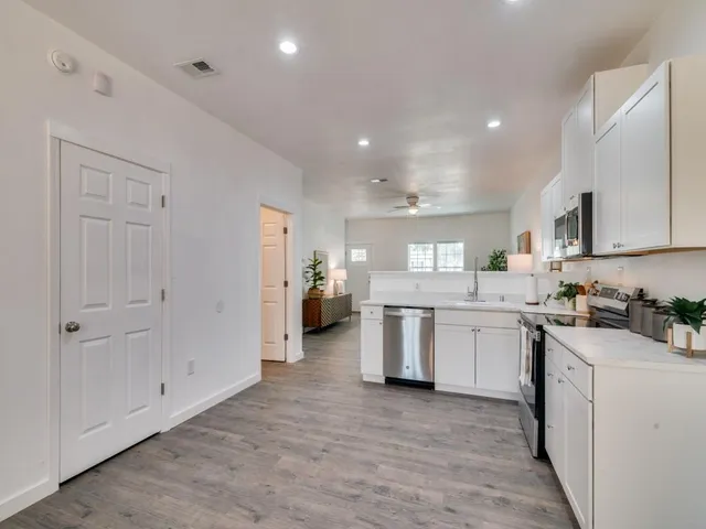 a kitchen with sink and cabinets