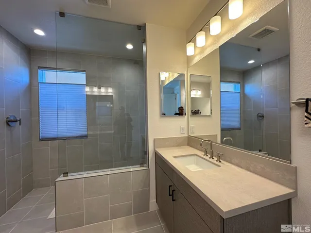a bathroom with a sink double vanity and a mirror