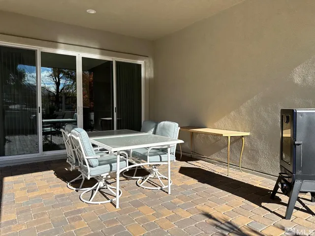 a view of a chair and tables in the patio