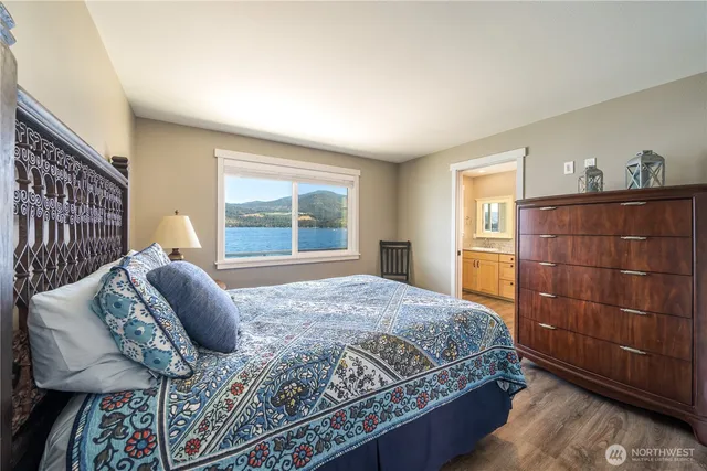 a bathroom with a granite countertop sink a mirror and a shower