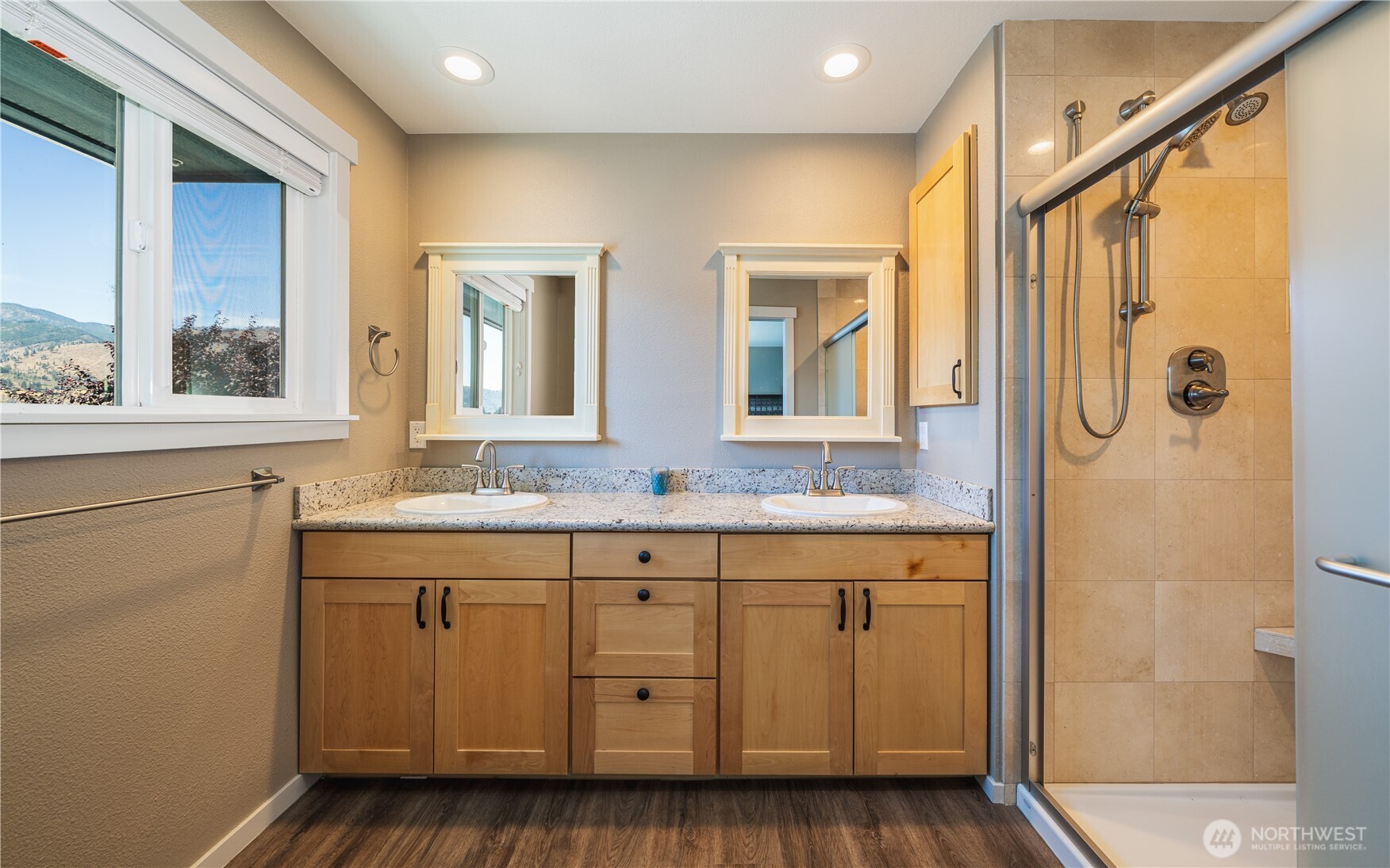 665 Manson Boulevard Manson, WA 98831 - Photo 15 of 39 a bathroom with a granite countertop sink a mirror and a shower