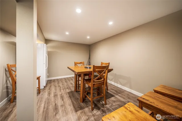 a bathroom with a granite countertop sink vanity mirror and toilet
