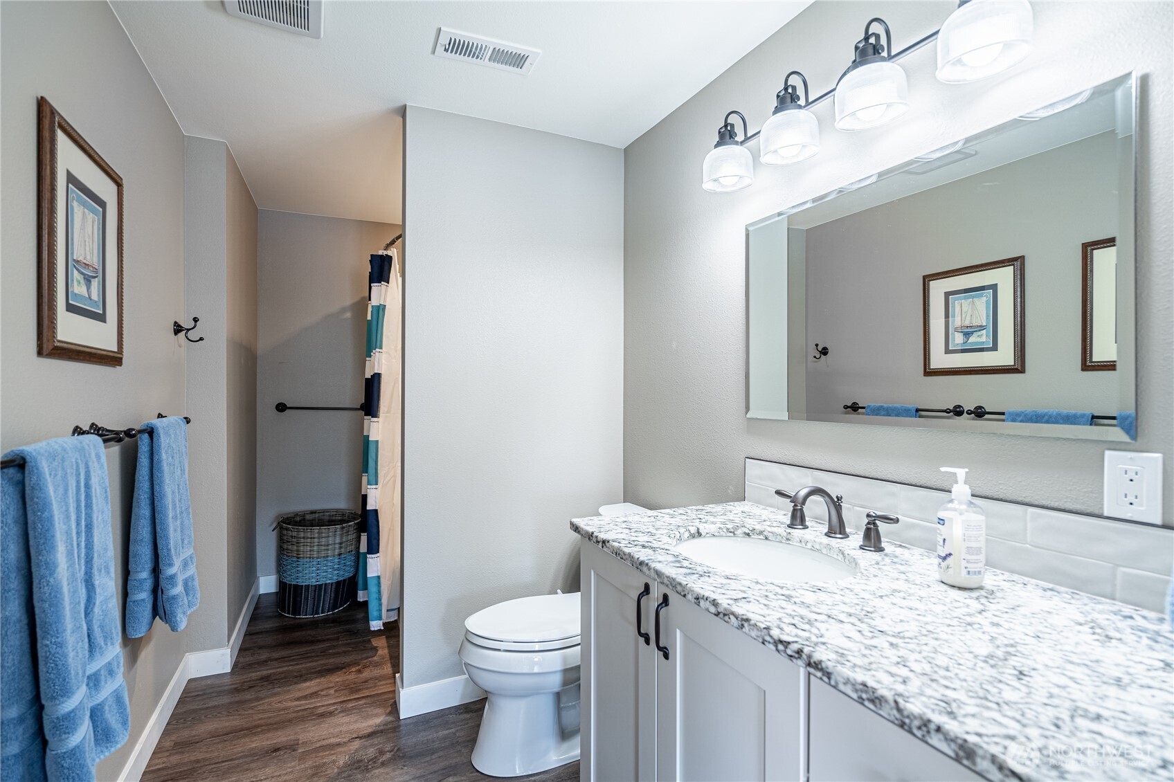 665 Manson Boulevard Manson, WA 98831 - Photo 22 of 39 a bathroom with a granite countertop sink vanity mirror and toilet