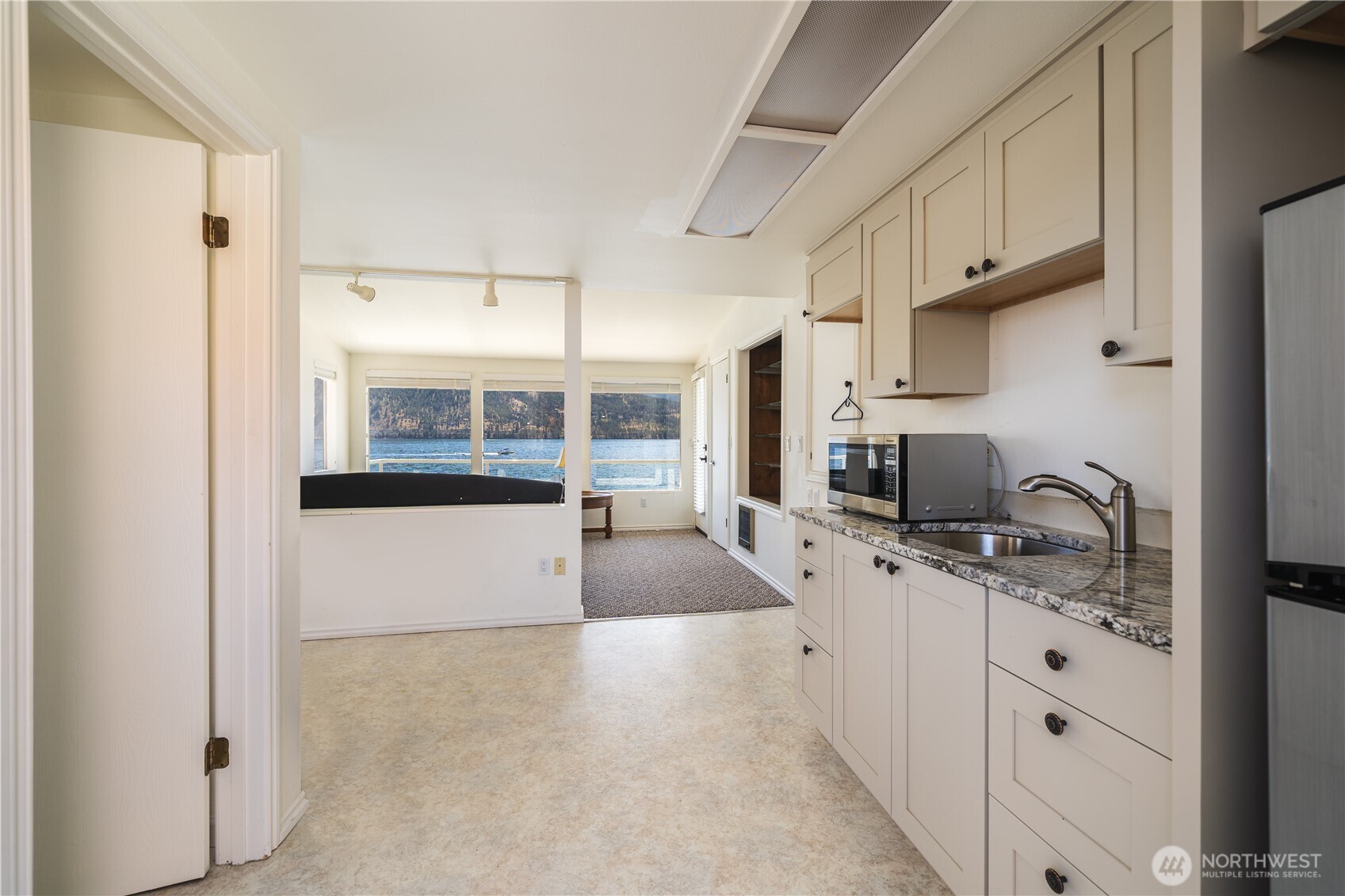 665 Manson Boulevard Manson, WA 98831 - Photo 25 of 39 a kitchen with stainless steel appliances granite countertop a sink and cabinets