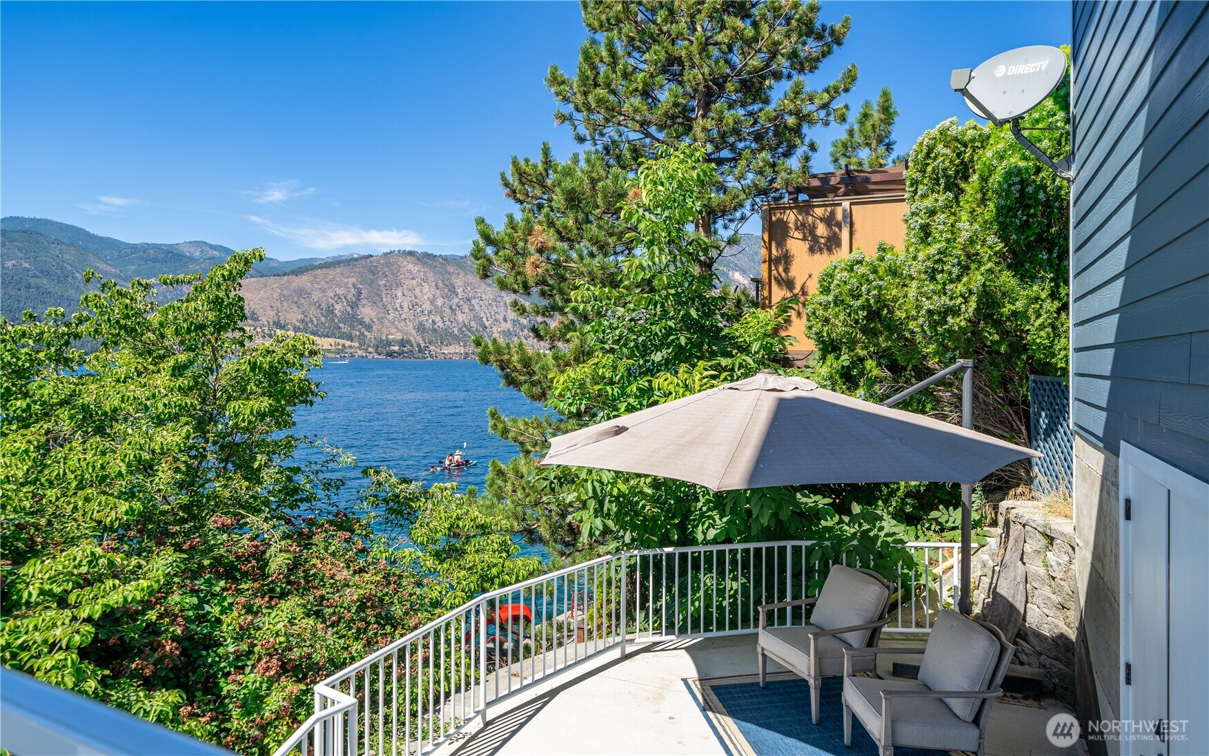 665 Manson Boulevard Manson, WA 98831 - Photo 30 of 39 a view of a deck with a table and chair under an umbrella
