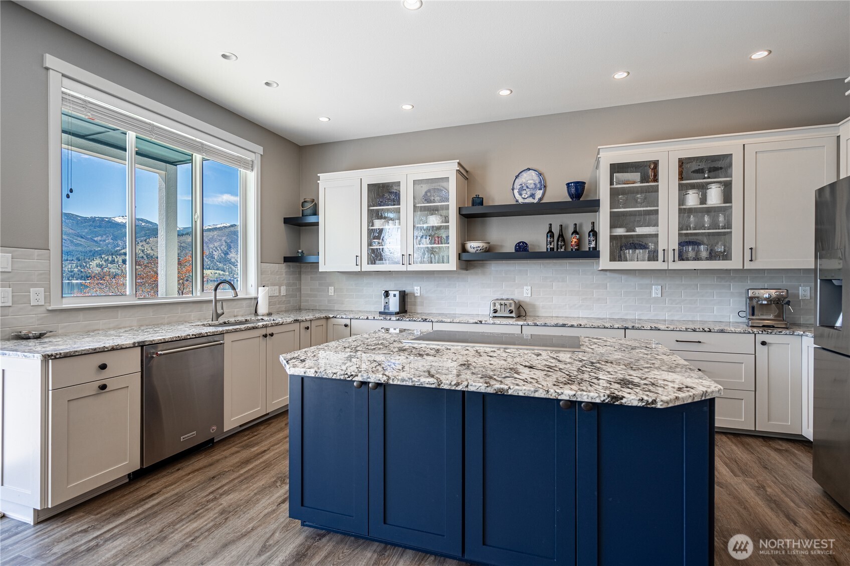 665 Manson Boulevard Manson, WA 98831 - Photo 3 of 39 a kitchen with stainless steel appliances granite countertop a sink and wooden cabinets