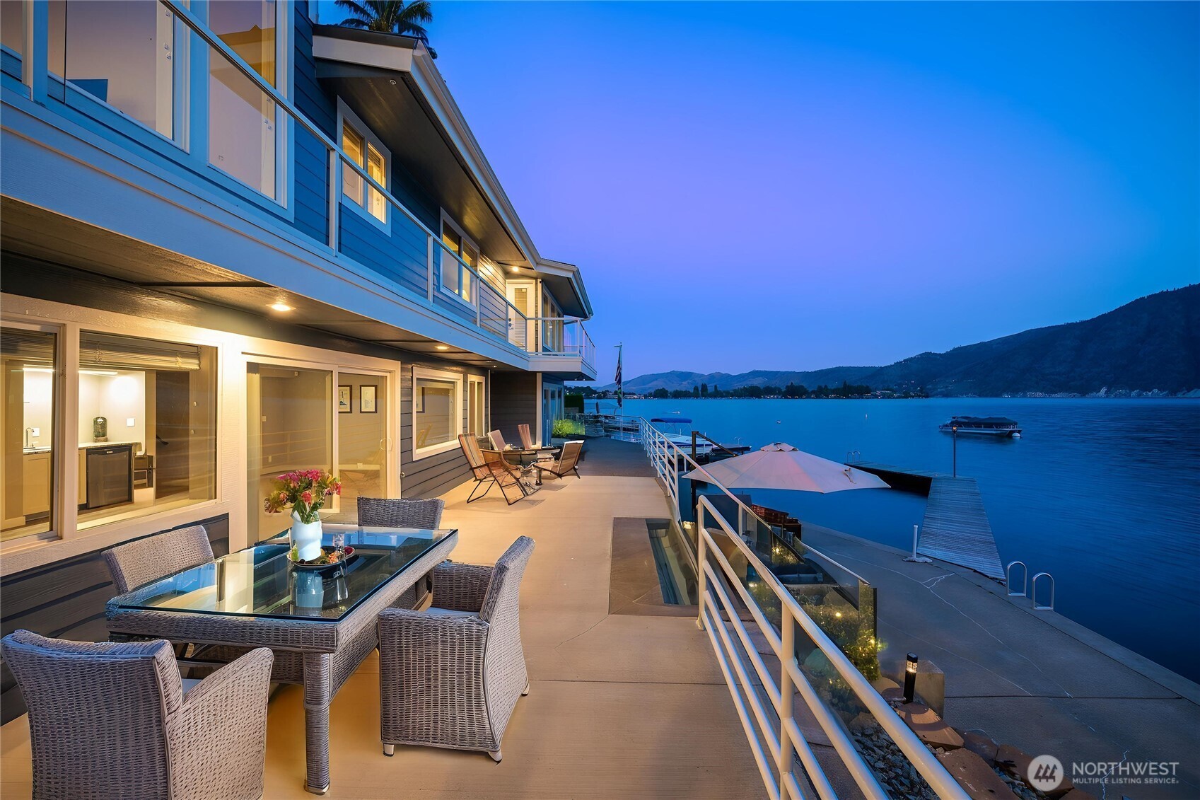 665 Manson Boulevard Manson, WA 98831 - Photo 31 of 39 a view of a patio with dining table and chairs with wooden floor