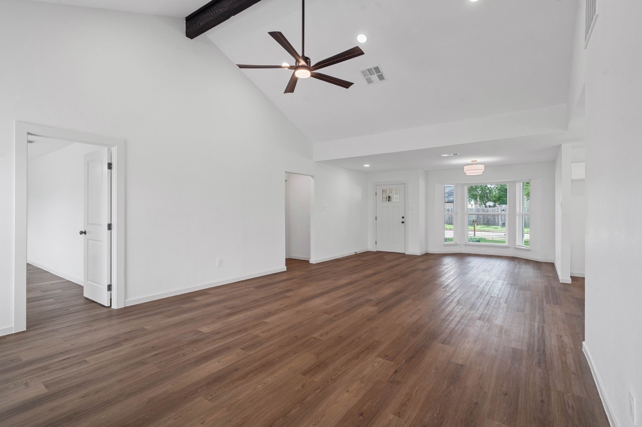 5326 Findlay Drive Pasadena, TX 77505 - Photo 11 of 50 Expansive open-concept living room with soaring vaulted ceilings, exposed beam, and durable wood-look plank flooring.