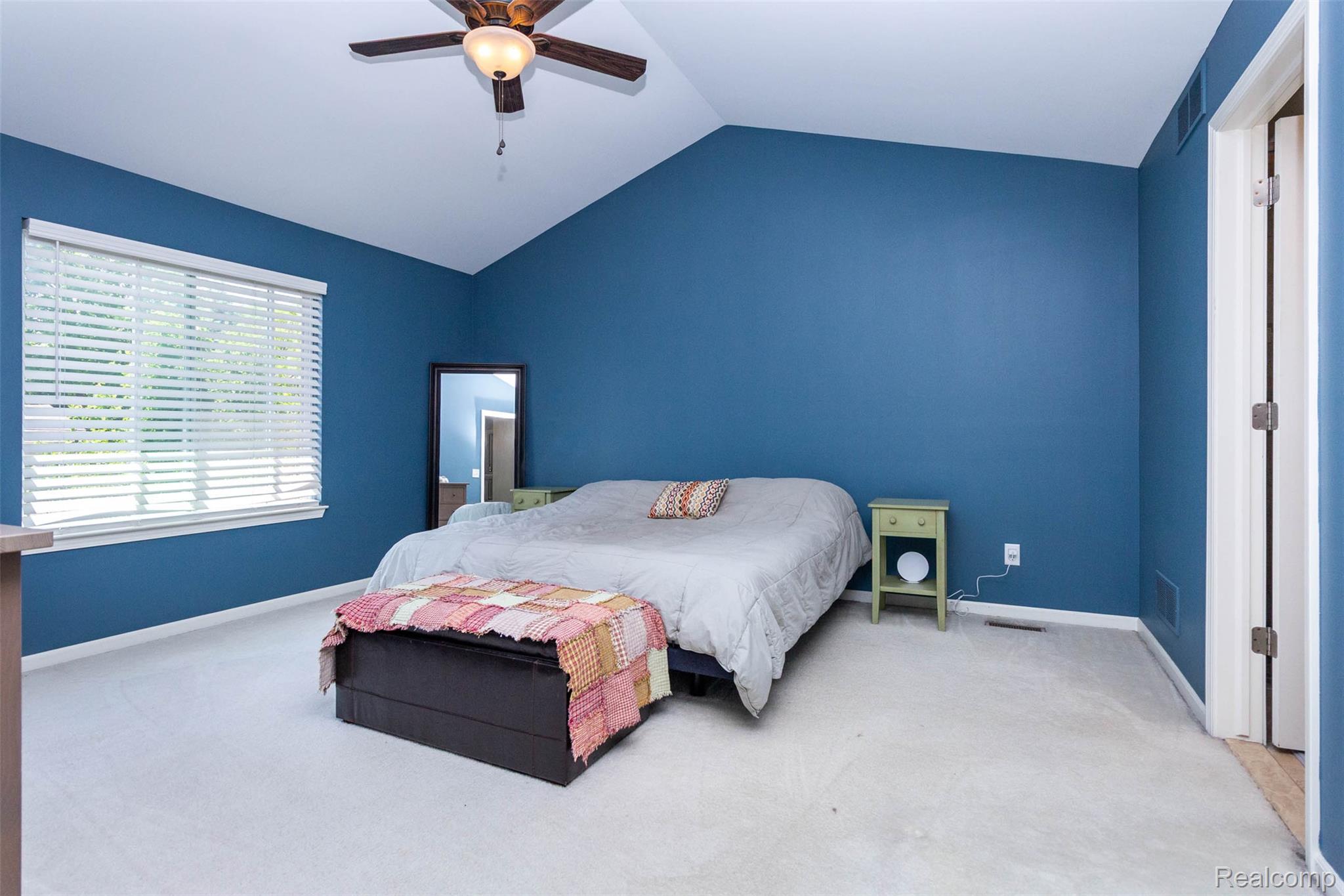 36039 Curtis Road Livonia, MI 48152 - Photo 19 of 61 Spacious bedroom featuring a vaulted ceiling and a ceiling fan with integrated lighting