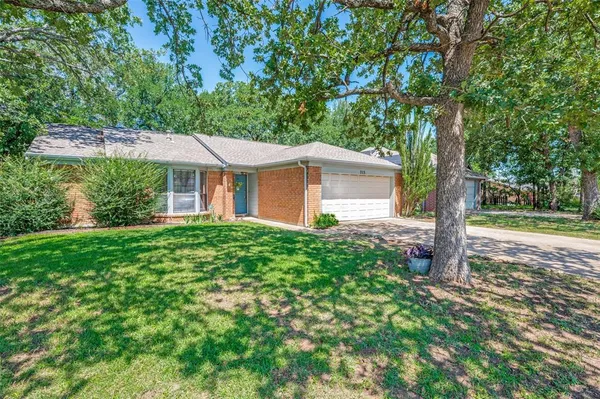 a view of a house with yard and tree s