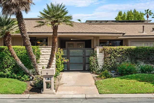 a view of a patio with table and chairs and potted plants