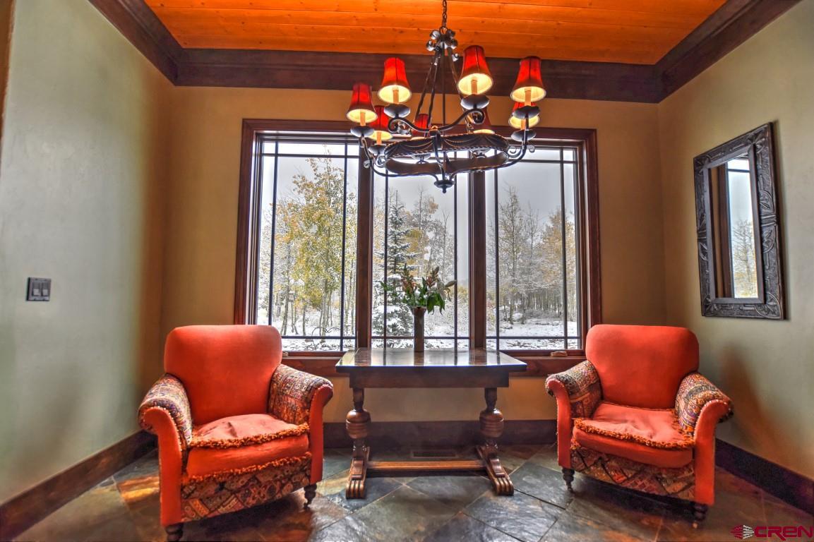 302 Maverick Lane Montrose, CO 81403 - Photo 11 of 35 a living room with furniture a chandelier and a window