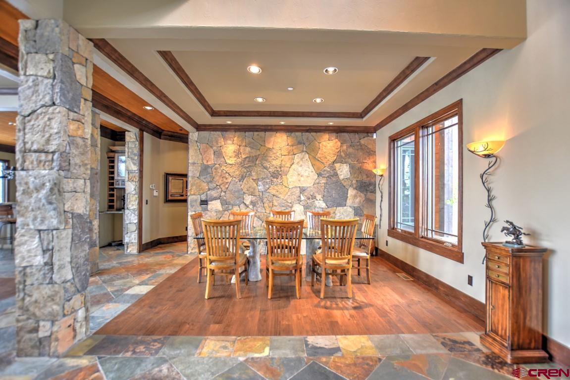 302 Maverick Lane Montrose, CO 81403 - Photo 13 of 35 a view of a dining room with furniture window and wooden floor