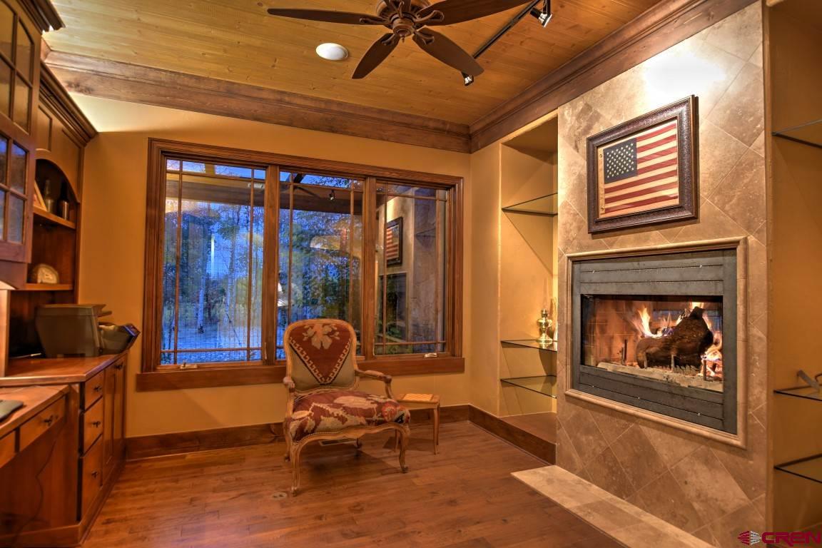 302 Maverick Lane Montrose, CO 81403 - Photo 15 of 35 a living room with furniture and a fireplace