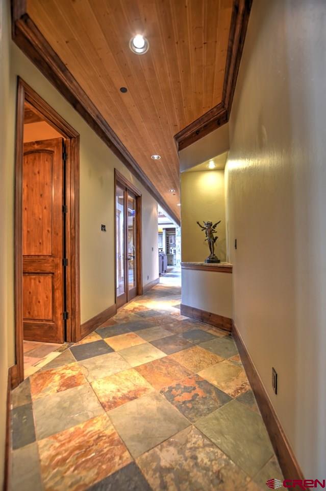 302 Maverick Lane Montrose, CO 81403 - Photo 16 of 35 a view of a hallway with wooden shelves