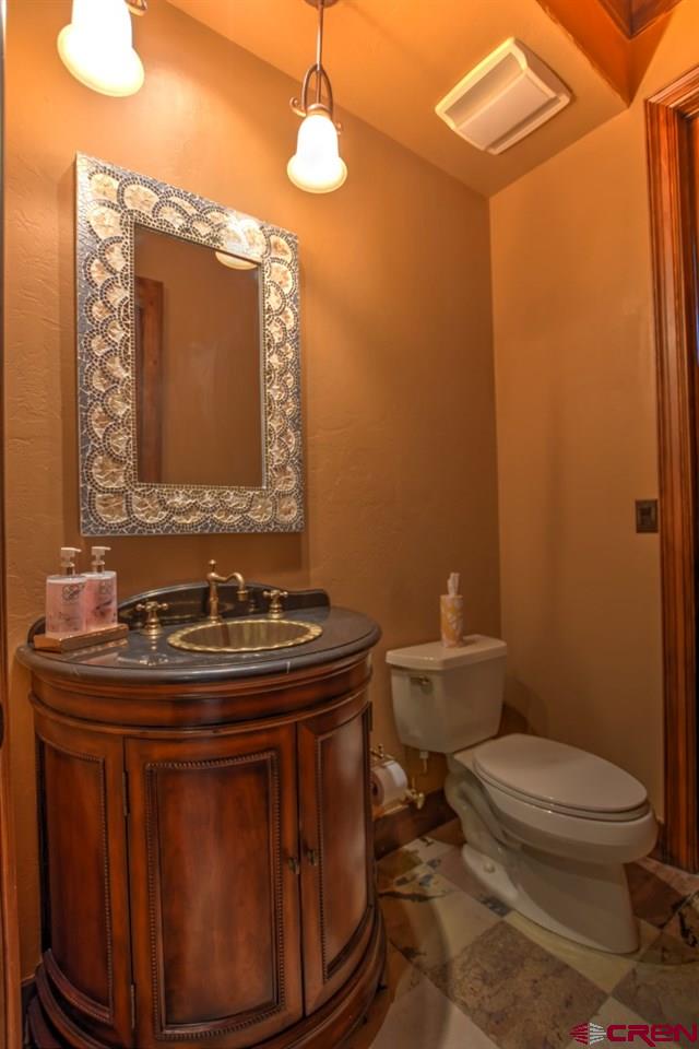 302 Maverick Lane Montrose, CO 81403 - Photo 22 of 35 a bathroom with a toilet a sink and mirror