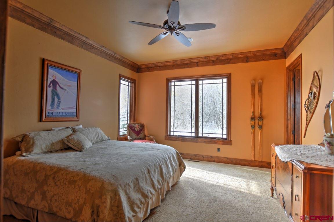 302 Maverick Lane Montrose, CO 81403 - Photo 24 of 35 a bedroom with a bed dresser and a window