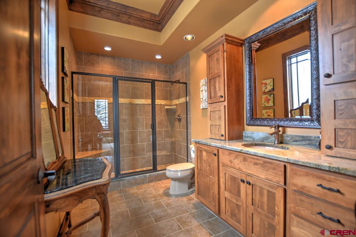 302 Maverick Lane Montrose, CO 81403 - Photo 25 of 35 a bathroom with a double vanity sink toilet and shower