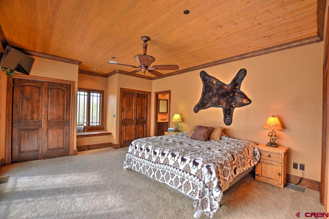 302 Maverick Lane Montrose, CO 81403 - Photo 28 of 35 a bedroom with a large bed and window