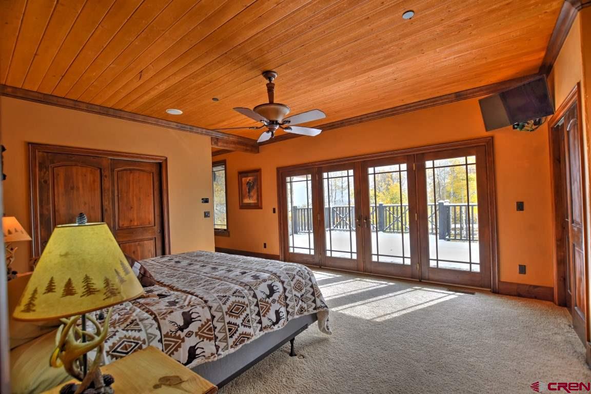 302 Maverick Lane Montrose, CO 81403 - Photo 29 of 35 a bedroom with a large bed and a window