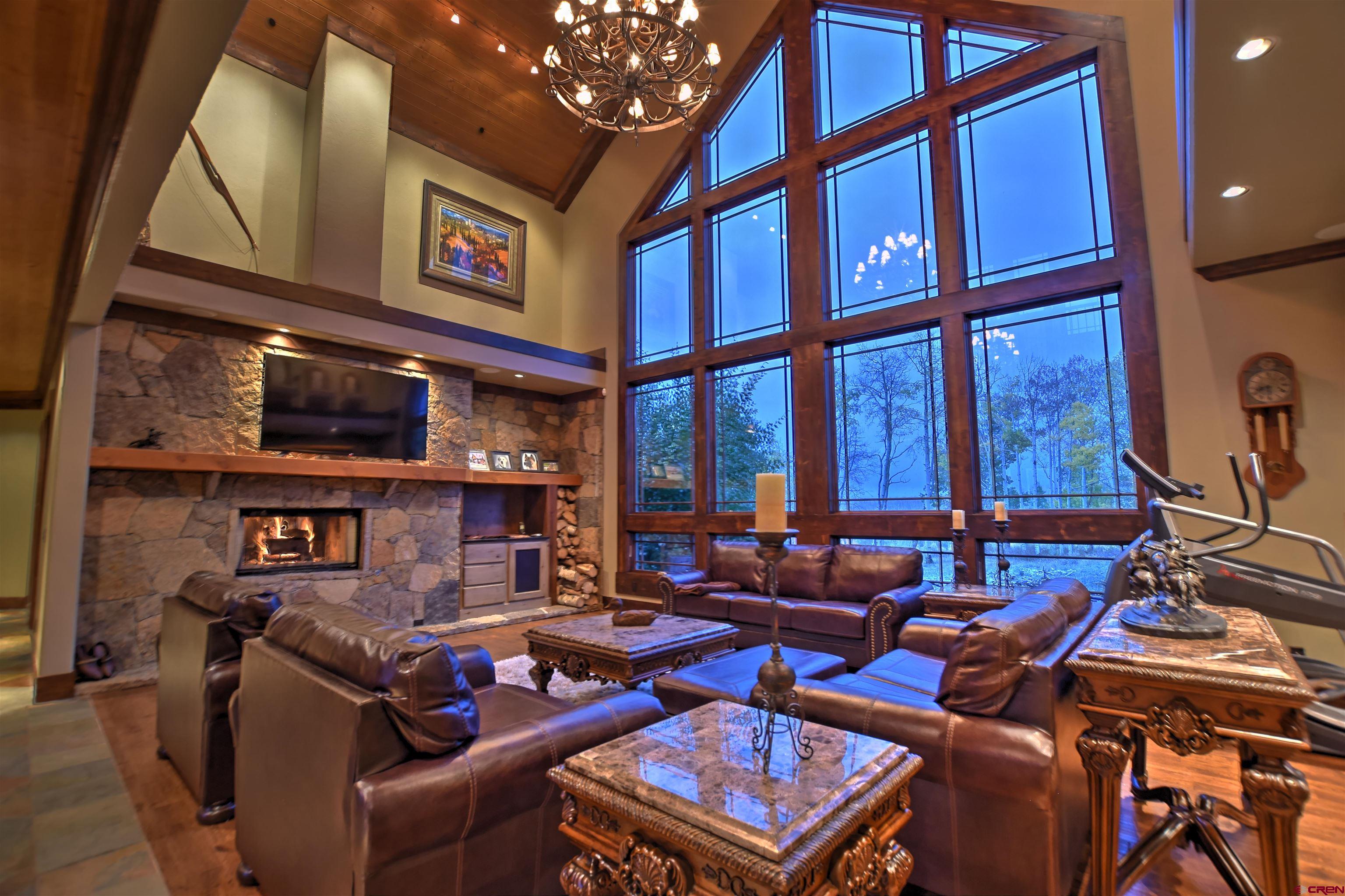 302 Maverick Lane Montrose, CO 81403 - Photo 4 of 35 a living room with furniture a window and a flat screen tv