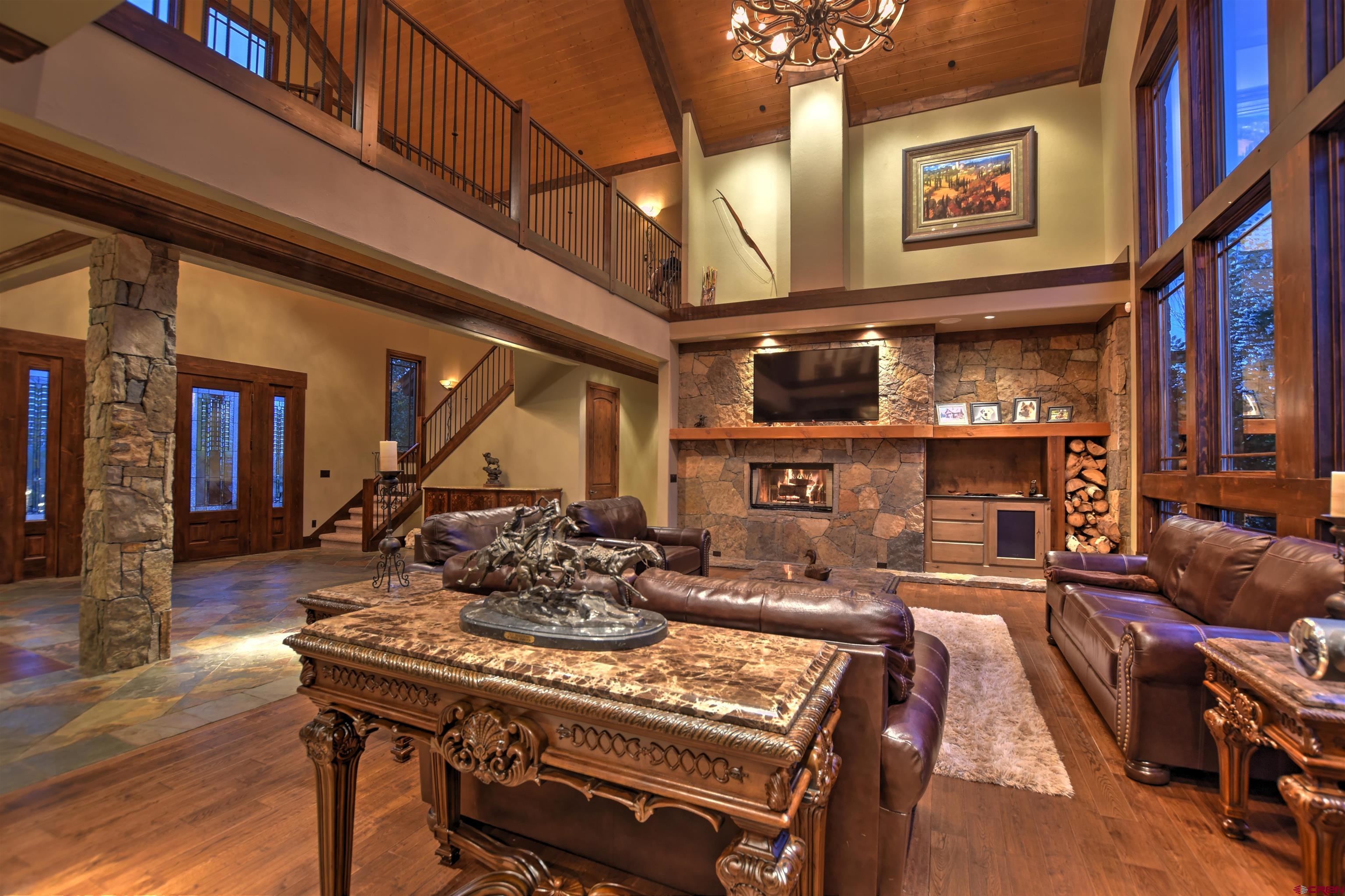 302 Maverick Lane Montrose, CO 81403 - Photo 5 of 35 a living room with furniture a fireplace and wooden floor