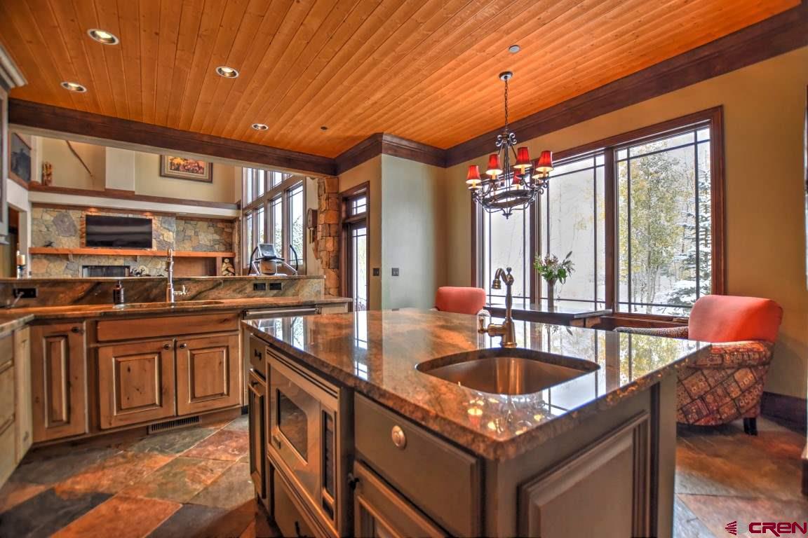 302 Maverick Lane Montrose, CO 81403 - Photo 7 of 35 a kitchen with granite countertop a sink and a stove