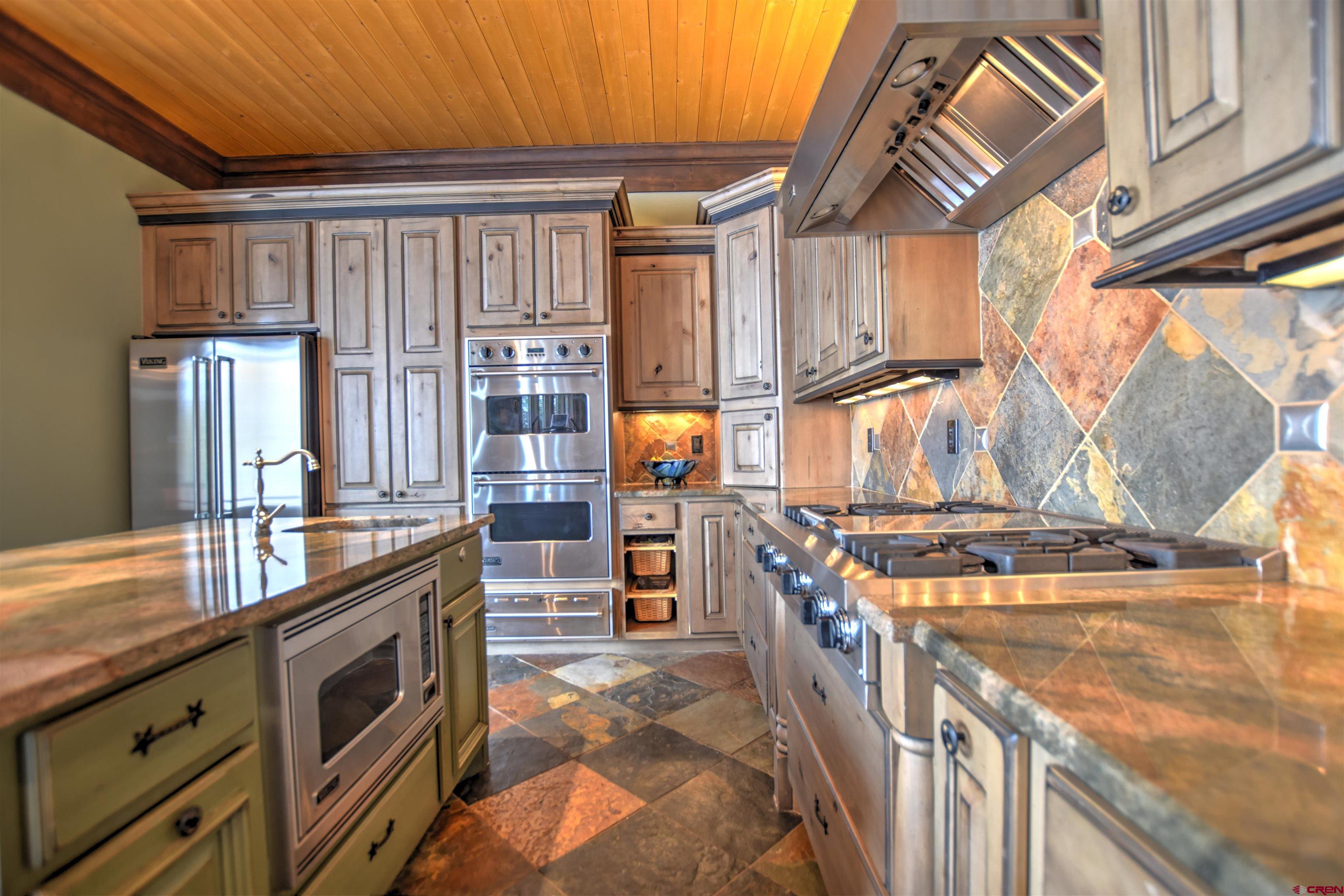 302 Maverick Lane Montrose, CO 81403 - Photo 8 of 35 a kitchen with stainless steel appliances granite countertop a stove a sink and a refrigerator