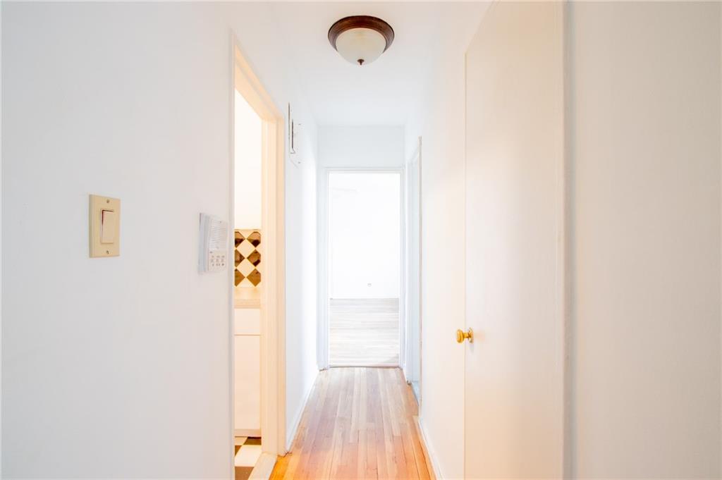 7259 Shore Road, Unit 6G Brooklyn, NY 11209 - Photo 11 of 30 a view of a hallway with wooden floor