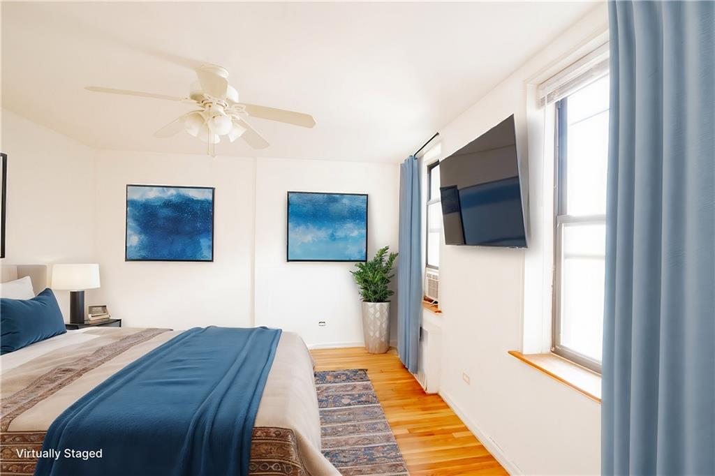 7259 Shore Road, Unit 6G Brooklyn, NY 11209 - Photo 12 of 30 a bedroom with a bed and a flat screen tv