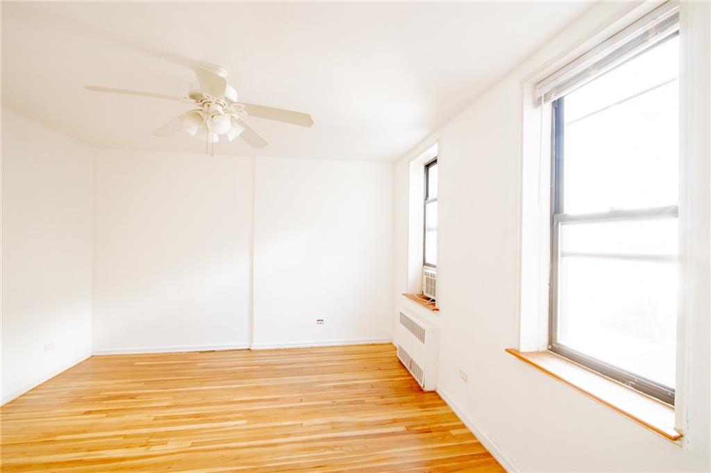 7259 Shore Road, Unit 6G Brooklyn, NY 11209 - Photo 13 of 30 a view of a room with wooden floor and fan