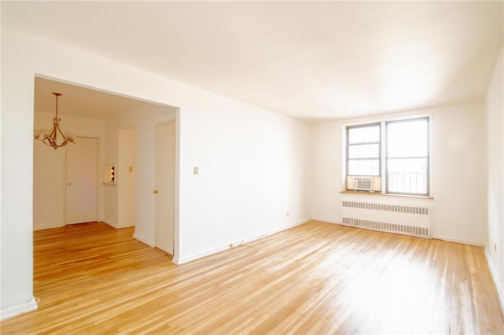 7259 Shore Road, Unit 6G Brooklyn, NY 11209 - Photo 2 of 30 a view of empty room with wooden floor and fan