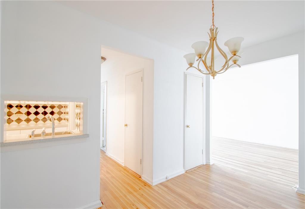 7259 Shore Road, Unit 6G Brooklyn, NY 11209 - Photo 3 of 30 a view of a room with wooden floor and white walls