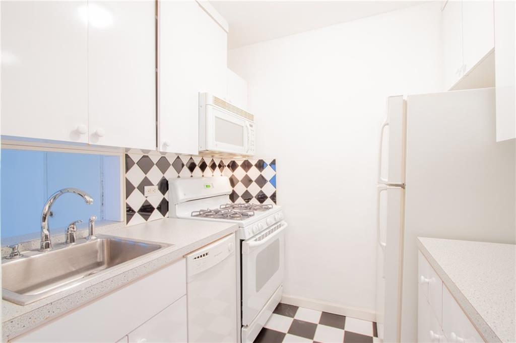 7259 Shore Road, Unit 6G Brooklyn, NY 11209 - Photo 4 of 30 a bathroom with a sink and a mirror