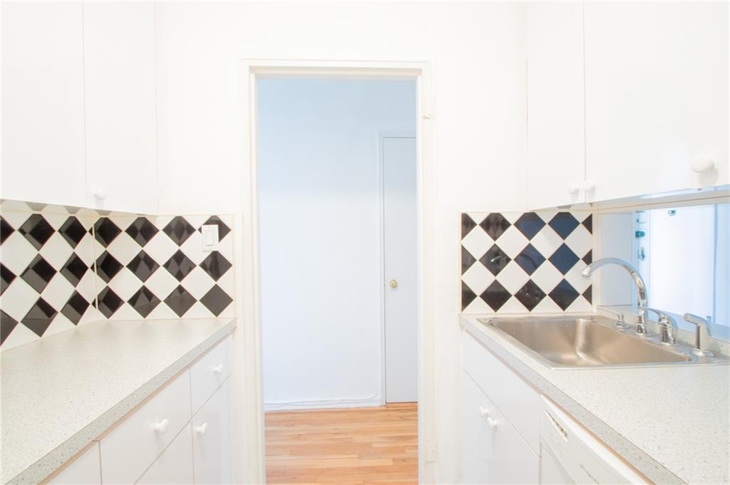 7259 Shore Road, Unit 6G Brooklyn, NY 11209 - Photo 5 of 30 a bathroom with a sink and a mirror