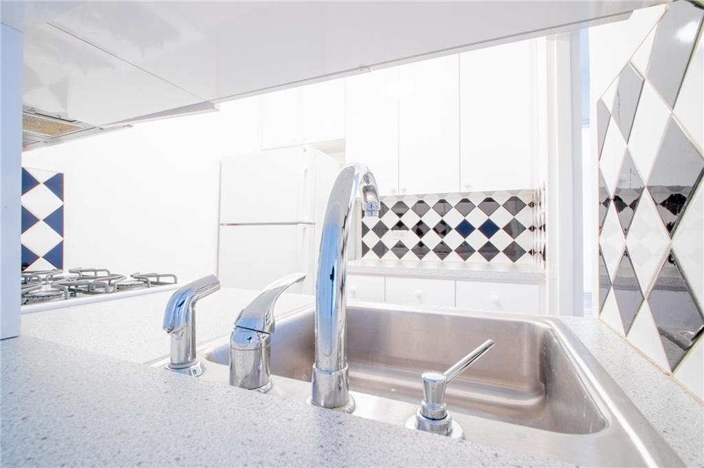 7259 Shore Road, Unit 6G Brooklyn, NY 11209 - Photo 6 of 30 a view of a room with racks on the wall and a large window