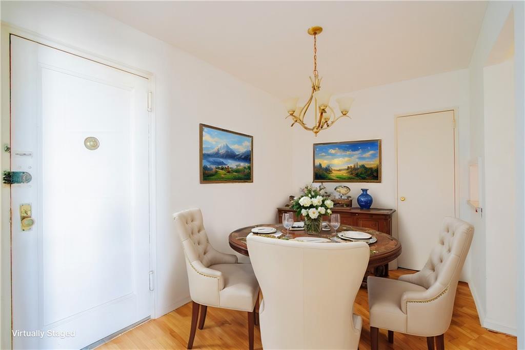 7259 Shore Road, Unit 6G Brooklyn, NY 11209 - Photo 7 of 30 a dining room with furniture a chandelier and wooden floor