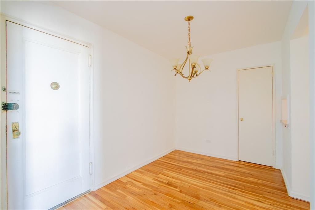 7259 Shore Road, Unit 6G Brooklyn, NY 11209 - Photo 8 of 30 a view of a room with wooden floor and white walls