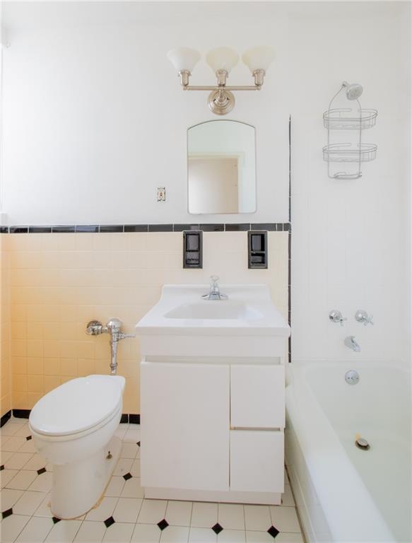 7259 Shore Road, Unit 6G Brooklyn, NY 11209 - Photo 9 of 30 a bathroom with a sink a toilet and shower